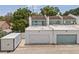Townhome's garages and flat roofs provide parking and deck space, complemented by mature landscaping at 3413 W Kirby St, Tampa, FL 33614