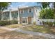Charming townhome featuring a stone facade, manicured lawn, and a welcoming front entrance at 3413 W Kirby St, Tampa, FL 33614