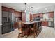 Spacious kitchen boasts wood cabinetry, a marble island, and modern stainless steel appliances at 3413 W Kirby St, Tampa, FL 33614