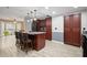 Open kitchen featuring a marble island with seating and stainless steel appliances at 3413 W Kirby St, Tampa, FL 33614