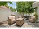 Outdoor patio featuring a wicker furniture set, gas fire pit and grill in a private backyard setting at 3413 W Kirby St, Tampa, FL 33614