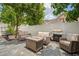 Cozy outdoor patio features wicker seating, a fire pit, and a grill, perfect for entertaining at 3413 W Kirby St, Tampa, FL 33614