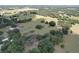 Panoramic aerial view showcasing the expansive property with lush greenery, ponds, and surrounding landscape at 3544 Porter Rd, Lithia, FL 33547