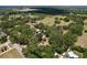 Scenic aerial view of a sprawling property with well-maintained pasture, mature trees, and residential buildings at 3544 Porter Rd, Lithia, FL 33547