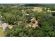 An aerial view of a home and acreage surrounded by lush trees, creating a private and tranquil setting at 3544 Porter Rd, Lithia, FL 33547