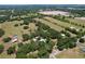 Stunning aerial view showcasing the expansive property with lush greenery, fields, and surrounding landscape at 3544 Porter Rd, Lithia, FL 33547