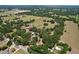 Captivating aerial view of the property showcasing its vast landscape, mature trees, and surrounding neighborhood at 3544 Porter Rd, Lithia, FL 33547