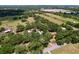 Aerial view of a property featuring expansive fields, mature trees, and well-maintained buildings at 3544 Porter Rd, Lithia, FL 33547