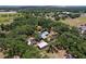 Aerial view showing the property layout with multiple structures nestled among trees at 3544 Porter Rd, Lithia, FL 33547