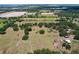 Breathtaking aerial view of the property featuring vast fields, scattered trees, and countryside charm at 3544 Porter Rd, Lithia, FL 33547