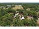 Expansive aerial shot of the property featuring buildings and surrounding woodlands at 3544 Porter Rd, Lithia, FL 33547