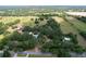 Expansive aerial view of a property showcasing the vast land, mature trees, and various structures at 3544 Porter Rd, Lithia, FL 33547