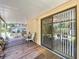 The covered back porch with wooden deck flooring offers a relaxing outdoor space at 3544 Porter Rd, Lithia, FL 33547