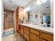 Bathroom featuring a double sink vanity with drawers, a large mirror, and a glass enclosed shower at 3544 Porter Rd, Lithia, FL 33547
