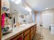 Bathroom featuring a double sink vanity with drawers, a large mirror, and multiple storage options at 3544 Porter Rd, Lithia, FL 33547