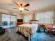 Bedroom featuring a ceiling fan, carpet, and a bed with patterned bedding at 3544 Porter Rd, Lithia, FL 33547