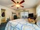 Bedroom featuring a ceiling fan, carpet, and a bed with patterned bedding at 3544 Porter Rd, Lithia, FL 33547
