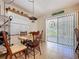 Dining area with wood table set and sliding glass doors that provide natural lighting at 3544 Porter Rd, Lithia, FL 33547