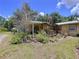 Charming home featuring an inviting covered porch adorned with lush greenery and potted plants, enhancing curb appeal at 3544 Porter Rd, Lithia, FL 33547
