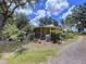 Charming home surrounded by lush gardens, featuring a covered porch and well-maintained yard, creating a serene setting at 3544 Porter Rd, Lithia, FL 33547