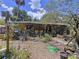 Home with inviting outdoor space, featuring lush greenery, decorative items, and comfortable seating creating a relaxing atmosphere at 3544 Porter Rd, Lithia, FL 33547