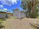 Side view of metal-sided cottage with visible windows and yard with sparse grass at 3544 Porter Rd, Lithia, FL 33547