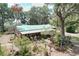Spacious home surrounded by lush greenery and well-maintained landscaping, featuring a metal roof and inviting outdoor spaces at 3544 Porter Rd, Lithia, FL 33547