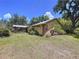 Ranch-style home featuring a metal roof, exterior brick accents, and a well-maintained yard at 3544 Porter Rd, Lithia, FL 33547