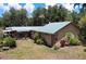 Ranch-style home featuring a metal roof, exterior brick accents, and a well-maintained yard at 3544 Porter Rd, Lithia, FL 33547