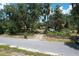 A captivating property featuring a quaint rural setting with lush trees, wood fence and gravel driveway at 3544 Porter Rd, Lithia, FL 33547