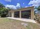 Large garage with three bays, door, and plentiful space for storage at 3544 Porter Rd, Lithia, FL 33547