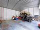 Spacious metal garage filled with equipment and storage, offering ample space for vehicles and projects at 3544 Porter Rd, Lithia, FL 33547