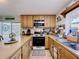 Traditional kitchen with warm oak cabinets, tile flooring, and an efficient layout for easy cooking and meal preparation at 3544 Porter Rd, Lithia, FL 33547