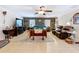 Spacious living room featuring tile flooring, ample seating, a ceiling fan, and cozy brick accents at 3544 Porter Rd, Lithia, FL 33547