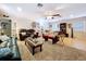 Bright living room features tile flooring, a ceiling fan, natural lighting, and comfortable seating at 3544 Porter Rd, Lithia, FL 33547