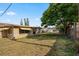 Spacious backyard with a well-maintained lawn and mature trees for shade and privacy at 3640 Cheswick Dr, Holiday, FL 34691