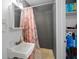 Cozy bathroom with a sink, shower, and storage shelves for toiletries and essentials at 3640 Cheswick Dr, Holiday, FL 34691