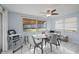 Bright dining room featuring neutral walls, tile flooring, and a modern ceiling fan at 3640 Cheswick Dr, Holiday, FL 34691