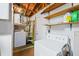 Unfinished laundry room featuring a washer, dryer, and open shelving for storage at 3640 Cheswick Dr, Holiday, FL 34691