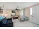 Comfortable living room with tile flooring, cozy seating, and abundant natural light at 3640 Cheswick Dr, Holiday, FL 34691