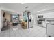 Open-concept living space features a modern kitchen and a cozy living area with tile flooring at 3640 Cheswick Dr, Holiday, FL 34691
