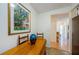 Charming breakfast nook with a wooden table, colorful artwork, and a view into the hallway at 368 Perth Ct # 368, Dunedin, FL 34698