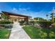 A community center and pool surrounded by lush greenery and a manicured lawn, perfect for gatherings at 368 Perth Ct # 368, Dunedin, FL 34698