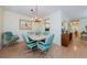 Inviting dining area featuring seating for six, a unique light fixture, and views into the kitchen at 368 Perth Ct # 368, Dunedin, FL 34698