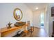Welcoming foyer with tiled floor, decor table, and a mirrored accent wall, complemented by natural light at 368 Perth Ct # 368, Dunedin, FL 34698