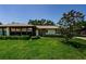 Charming home with mature tree, inviting screened-in porch and a well-manicured lawn at 368 Perth Ct # 368, Dunedin, FL 34698