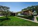 Well-maintained single-story home featuring mature trees, manicured shrubs, and inviting screened-in porch at 368 Perth Ct # 368, Dunedin, FL 34698