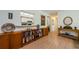 Hallway featuring built-in shelving, artwork, and light hardwood floors, leading to other areas of the home at 368 Perth Ct # 368, Dunedin, FL 34698