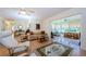 Bright living room featuring hardwood floors, neutral tones, open floor plan, and access to the sunroom at 368 Perth Ct # 368, Dunedin, FL 34698