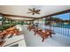 Outdoor picnic area with wooden tables, ceiling fans, and access to the community pool at 368 Perth Ct # 368, Dunedin, FL 34698